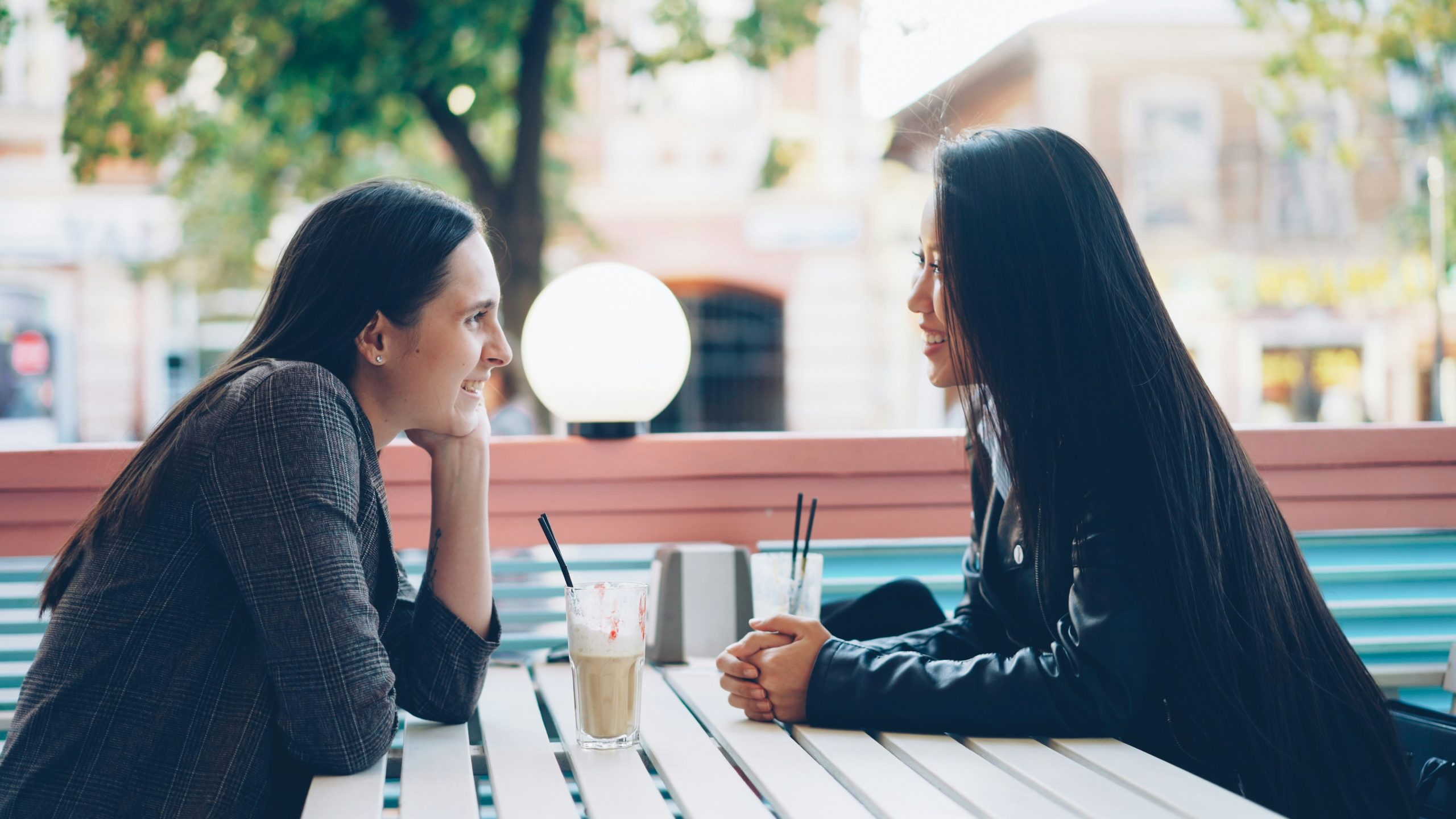 two friends talking at a cafe — love languages in friendship