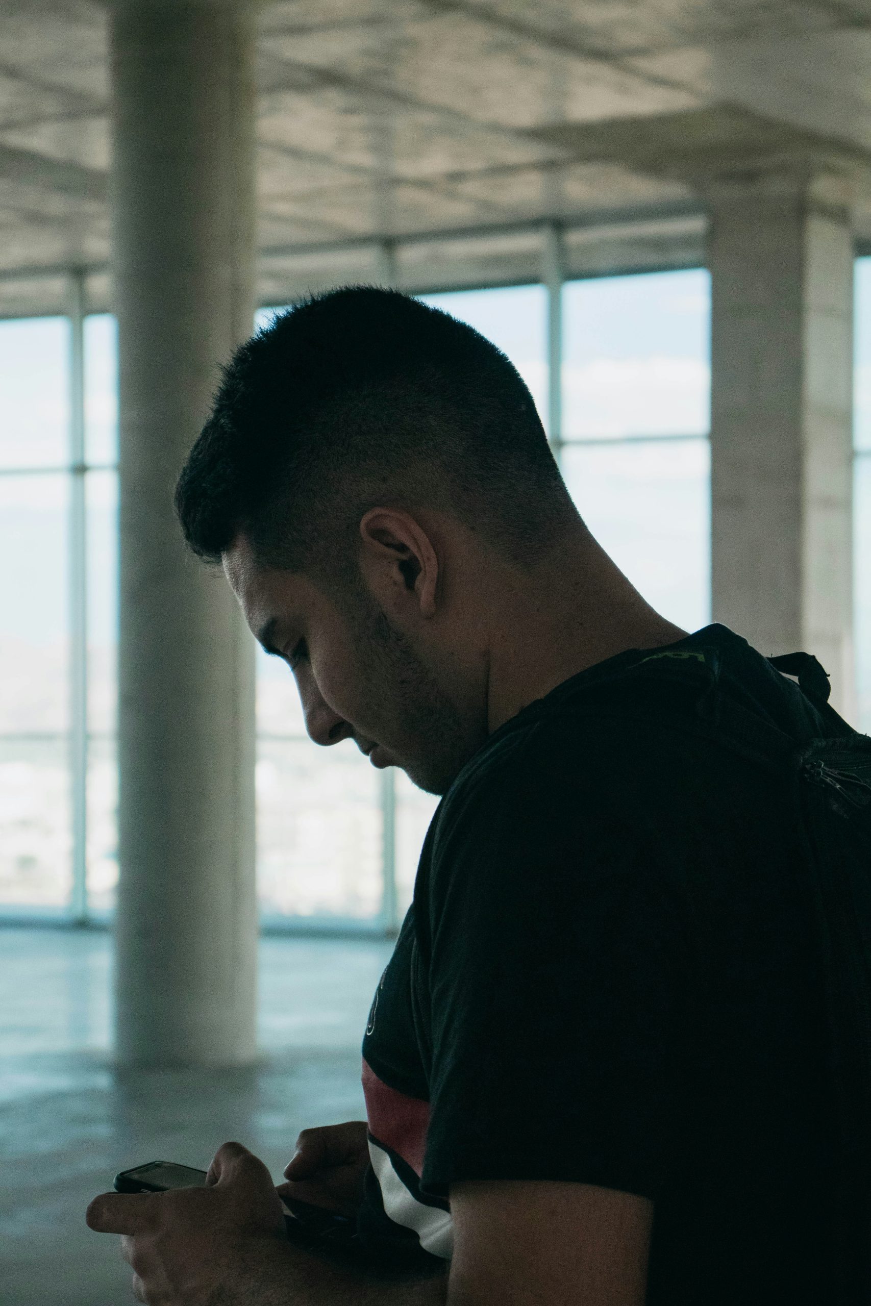 Man checking phone alone — anxious attachment triggers