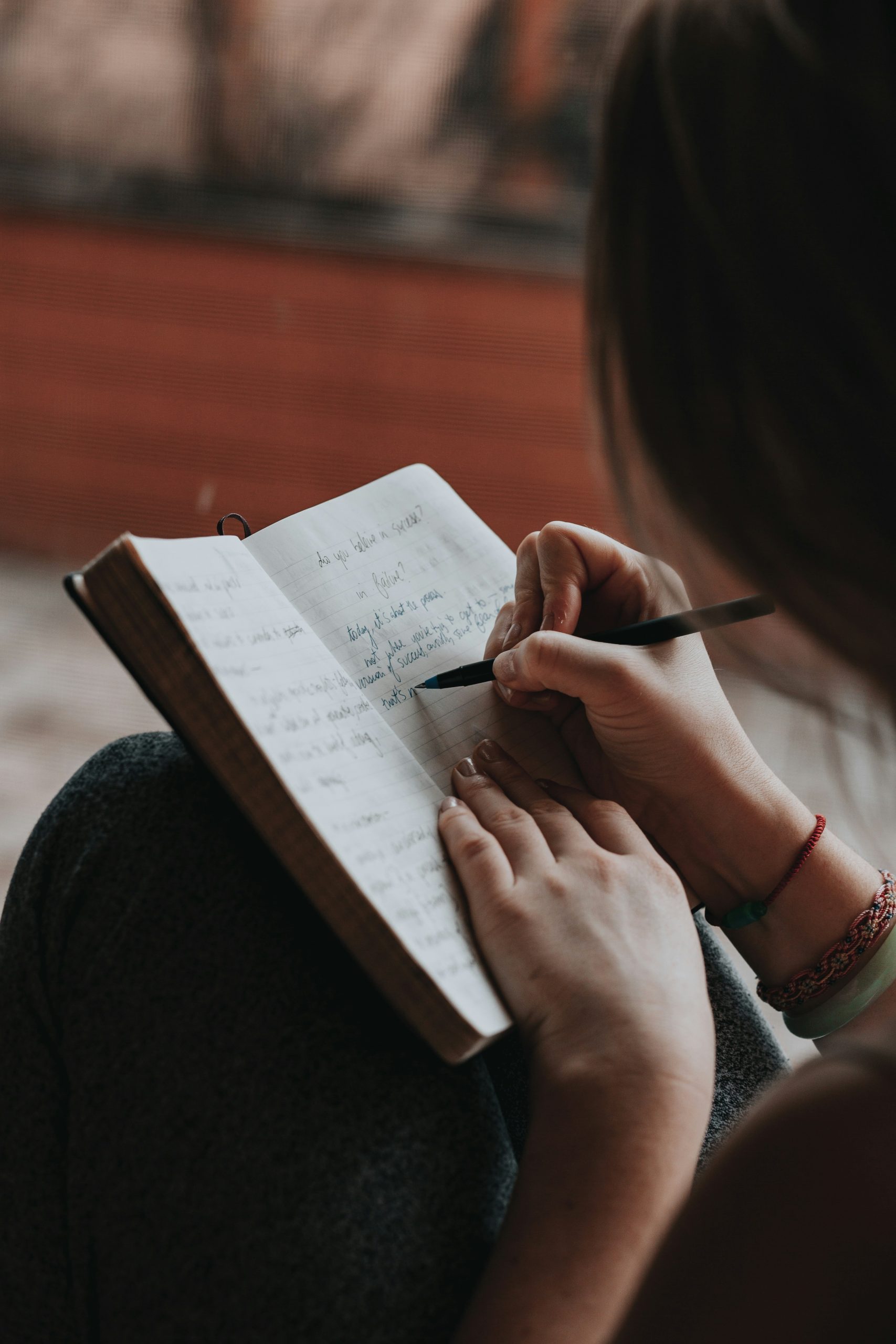 woman writing in a journal as a sign of healing from anxious attachment