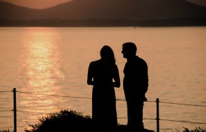 Couple standing in silence at sunset — avoidant attachment and conflict